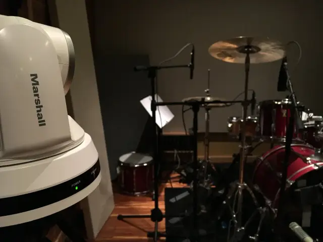 Recording studio with drum set and Marshall camera.