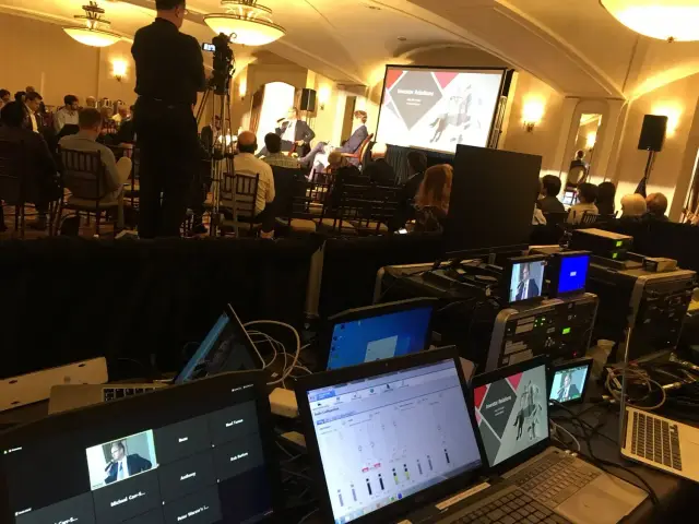 Control room setup at a business conference.