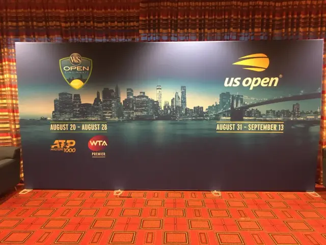 Promotional banner displaying information for the Western & Southern Open and US Open tennis tournaments with logos, a city skyline backdrop, and event dates.